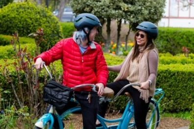 a group of people riding on the back of a bicycle